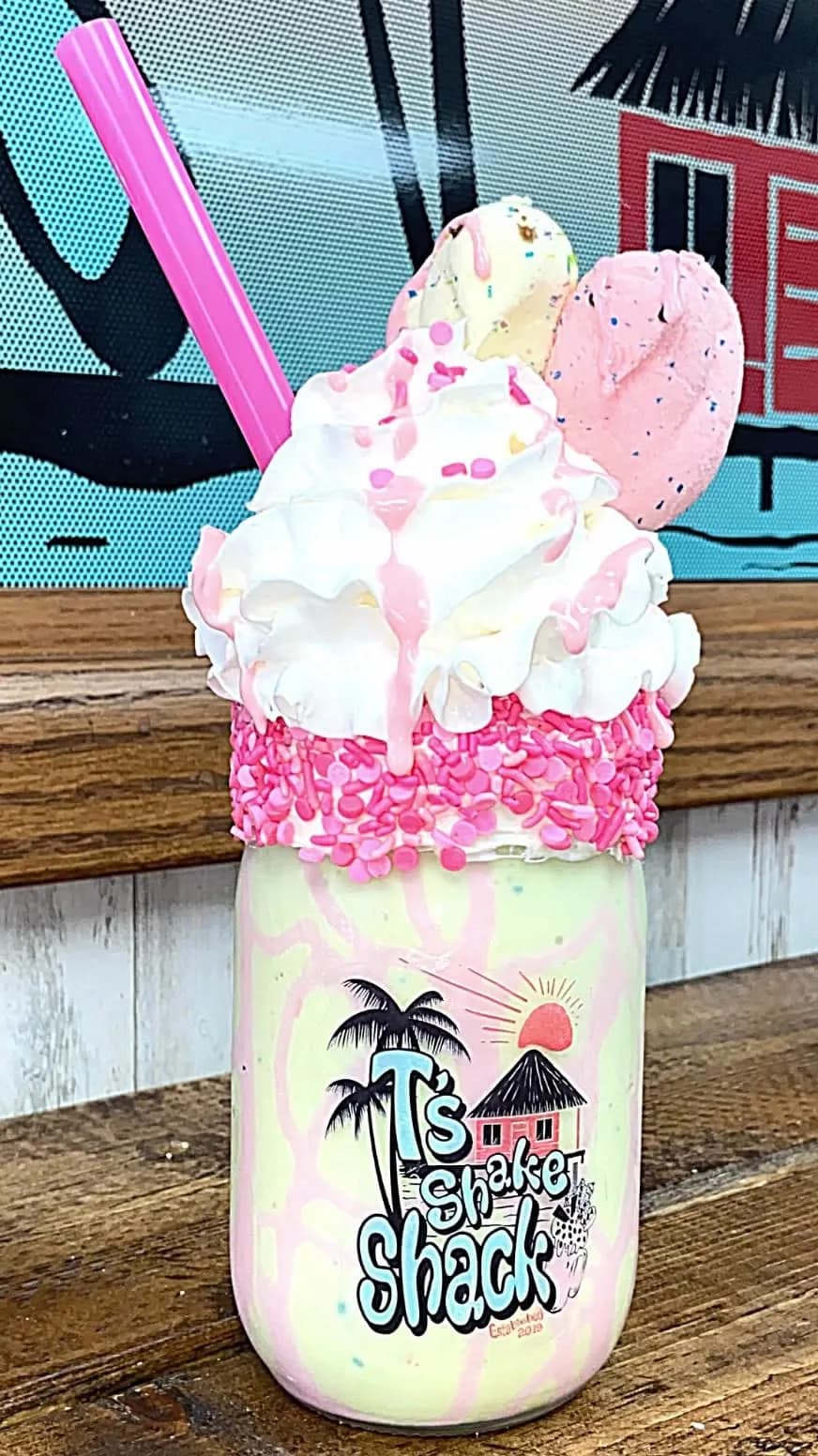 A strawberry milkshake crowned with scoops of ice cream