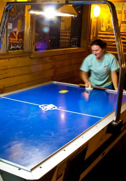 A game of air hockey in the game room at Freddy T’s